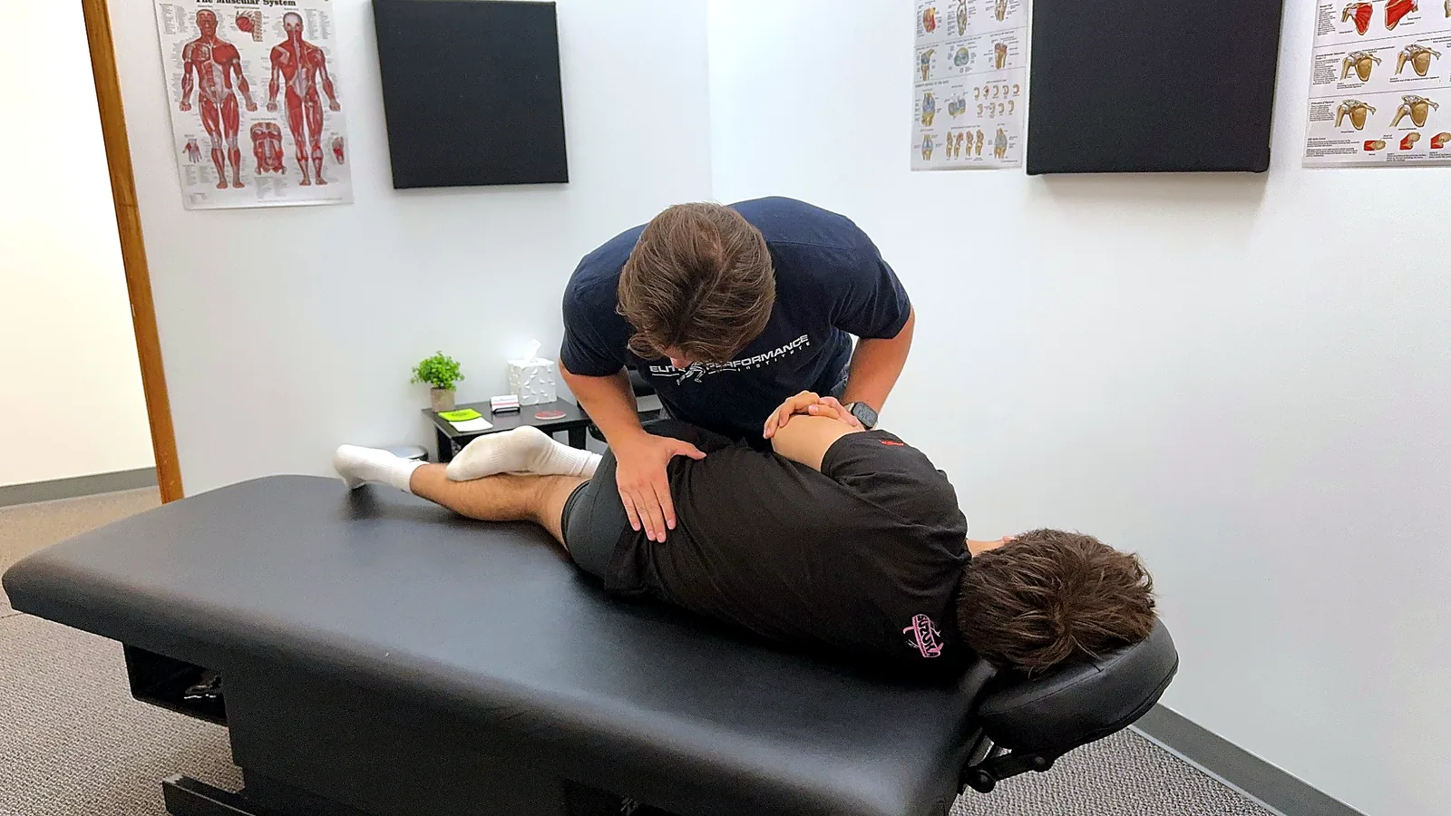 Dr. Max performing a chiropractic adjustment at Elite Performance Institute in Naperville Illinois